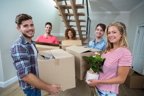 Moving service in Colliers Wood handling boxes and furniture carefully