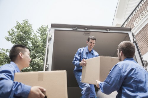 Removal team preparing furniture with safety focus in Colliers Wood