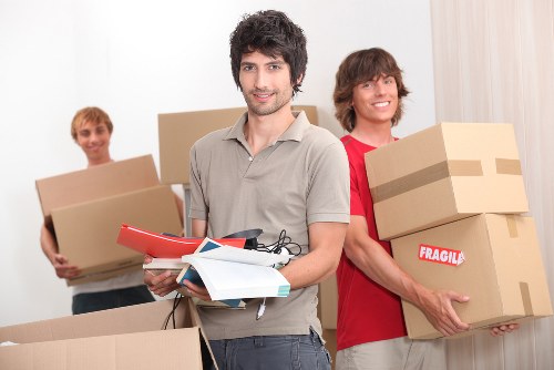 Organised office move with labelled boxes and furniture ready for transport