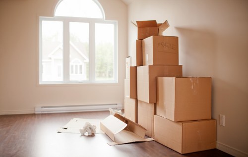 Moving van and packed boxes representing a free quote for Colliers Wood removals