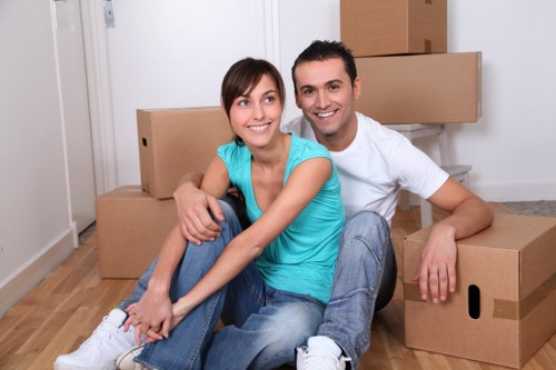 Trained removals staff carrying furniture carefully through a property