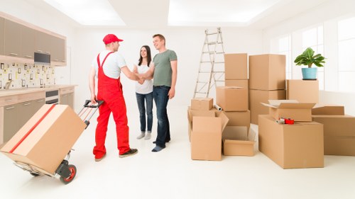Van moving furniture and boxes near Colliers Wood homes and flats