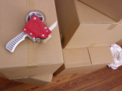 Mover wearing PPE while handling boxes safely