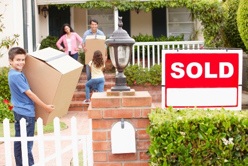 Packed boxes and furniture prepared for same day removals in a Colliers Wood flat