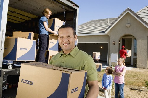 Loading household items into a removals truck in Colliers Wood